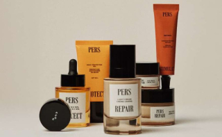 Nature morte présentant une gamme de produits de soin de la marque PERS, incluant un flacon à pipette, des pots de crème et des tubes (protection solaire et rétinol), avec un design d'emballage minimaliste.